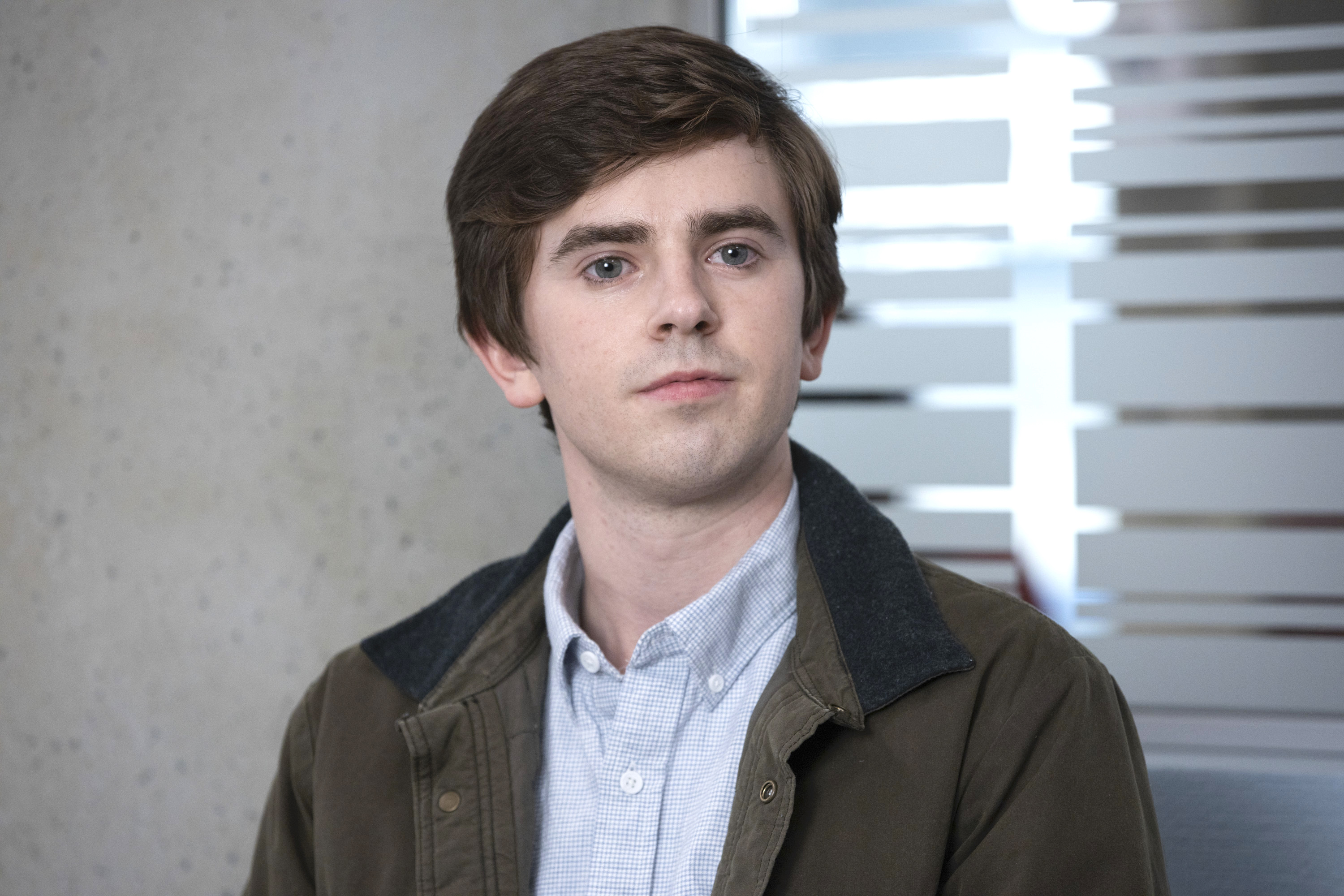 A still from the TV show 'The Good Doctor' showing the main character Dr. Shaun Murphy played by Freddie Highmore.