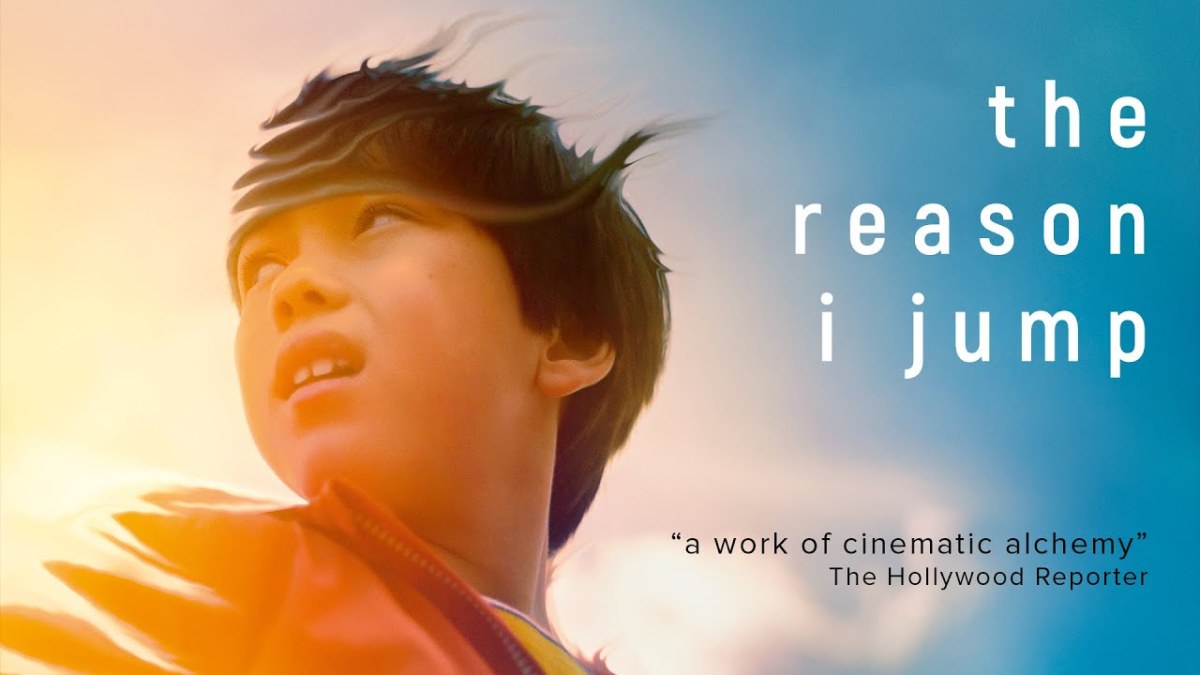 Movie Screenshot of the reason i jump, close up of a young boys face as he looks behind him. Text reads: the reason I jump. "A work of cinematic alchemy" the hollywood reporter.